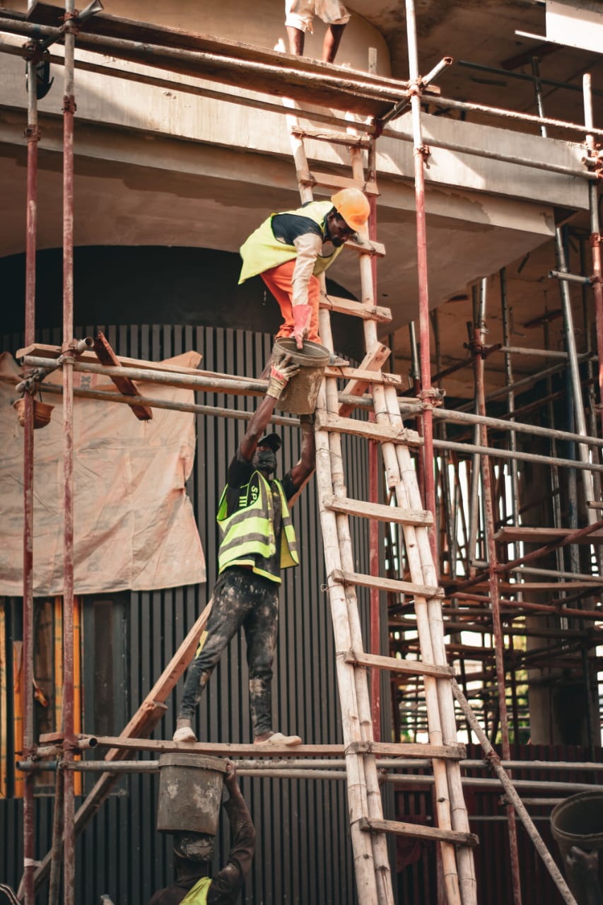 Construction workers on scaffolding at a building site